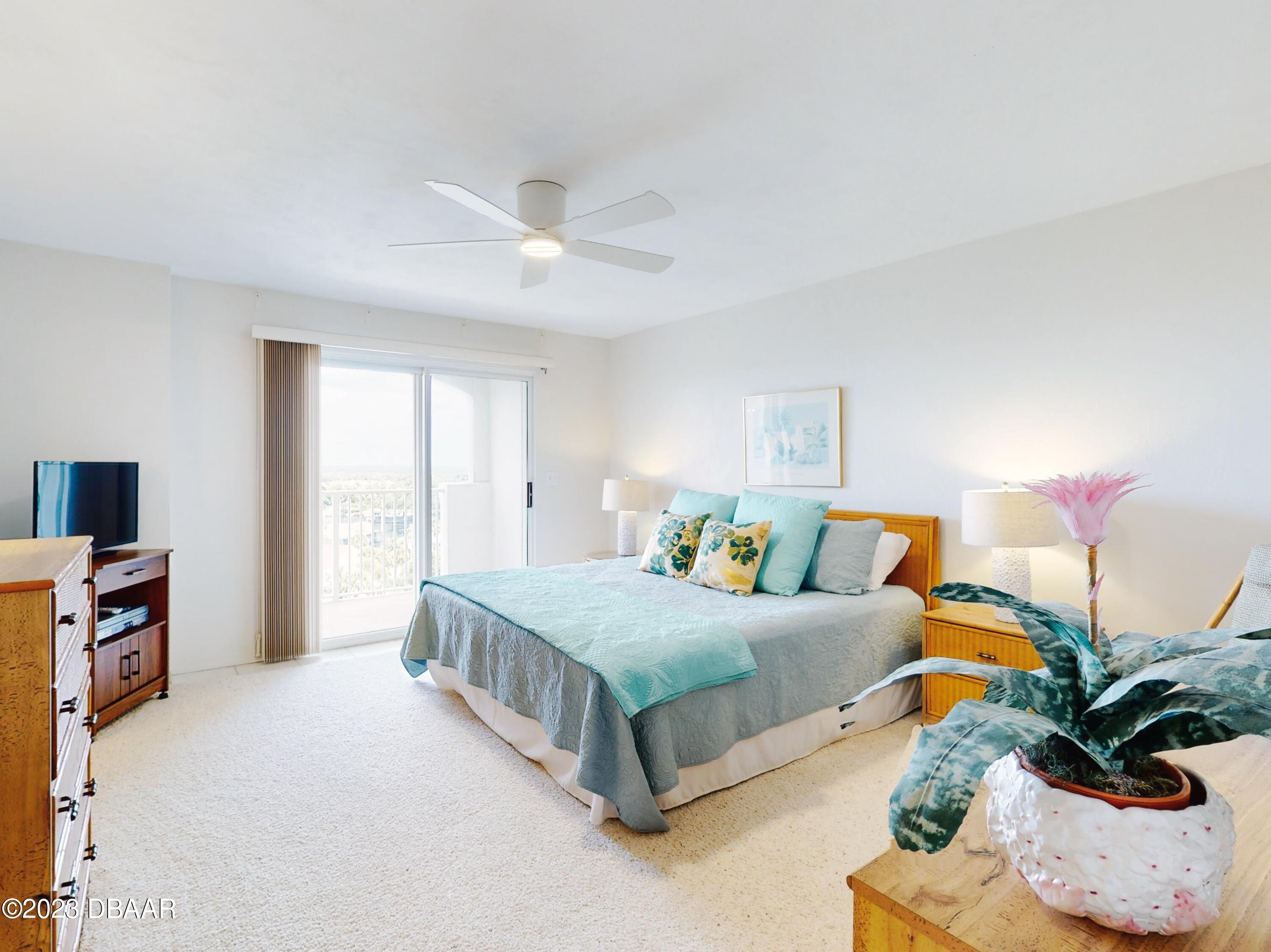 1 John Anderson Drive, Unit PH7 Ormond Beach, FL 32176 - Photo 7 of 134 a bedroom with a bed potted plant on dresser and a window