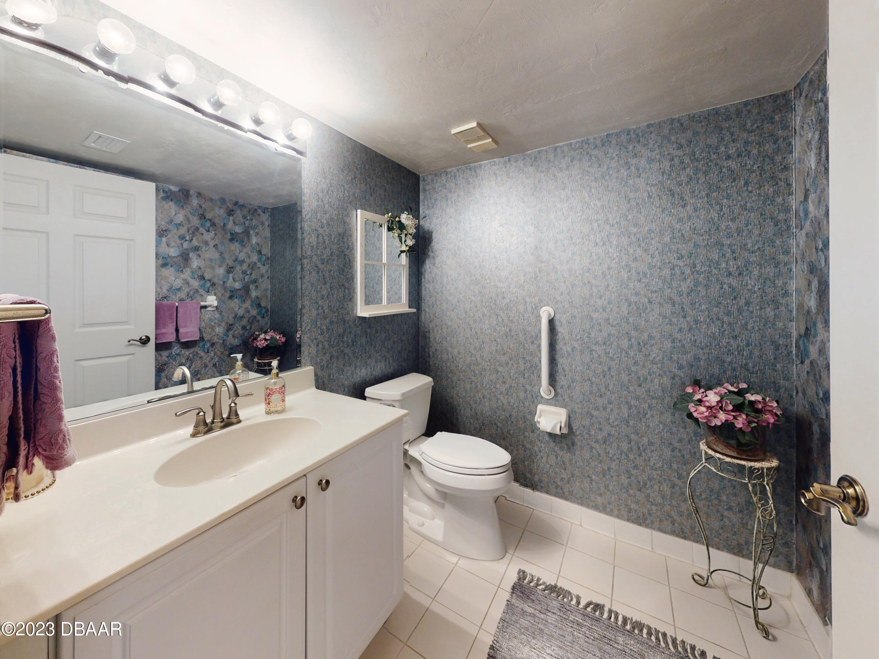 1 John Anderson Drive, Unit PH7 Ormond Beach, FL 32176 - Photo 73 of 134 a bathroom with a sink mirror and toilet