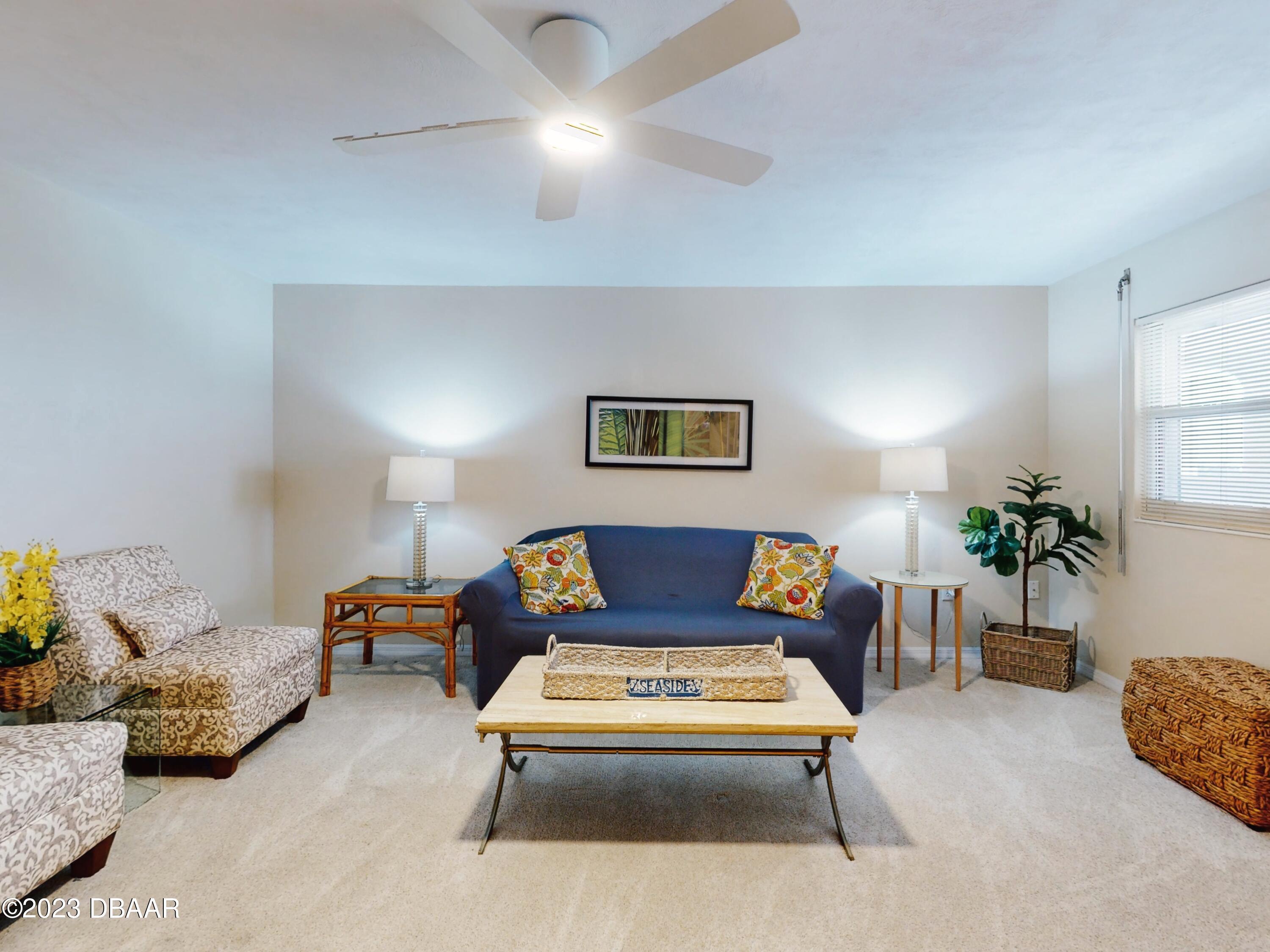 1 John Anderson Drive, Unit PH7 Ormond Beach, FL 32176 - Photo 76 of 134 a living room with furniture and a chandelier