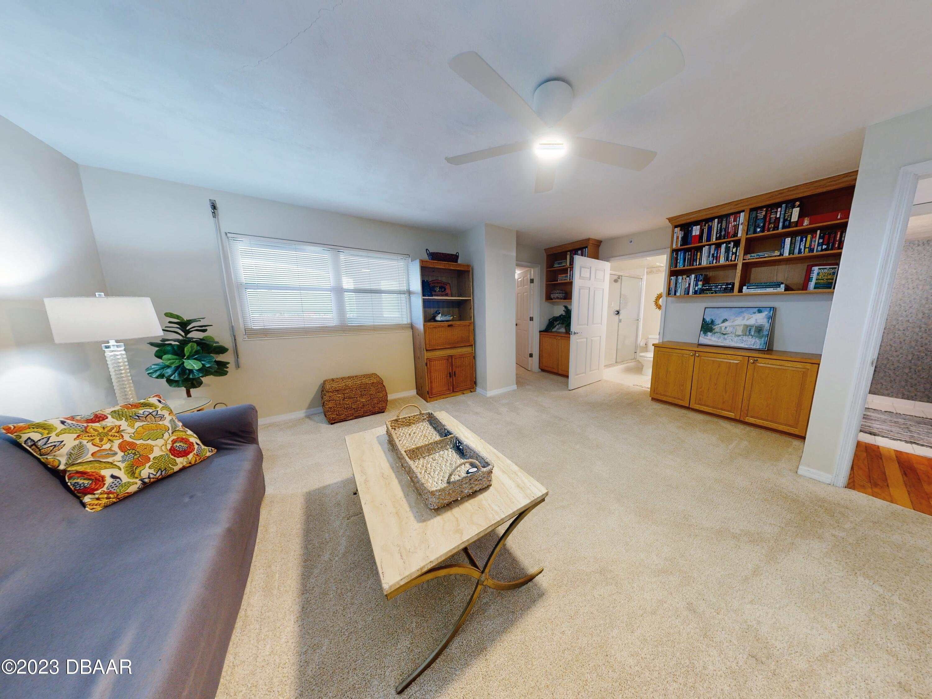 1 John Anderson Drive, Unit PH7 Ormond Beach, FL 32176 - Photo 78 of 134 a living room with furniture and a book shelf