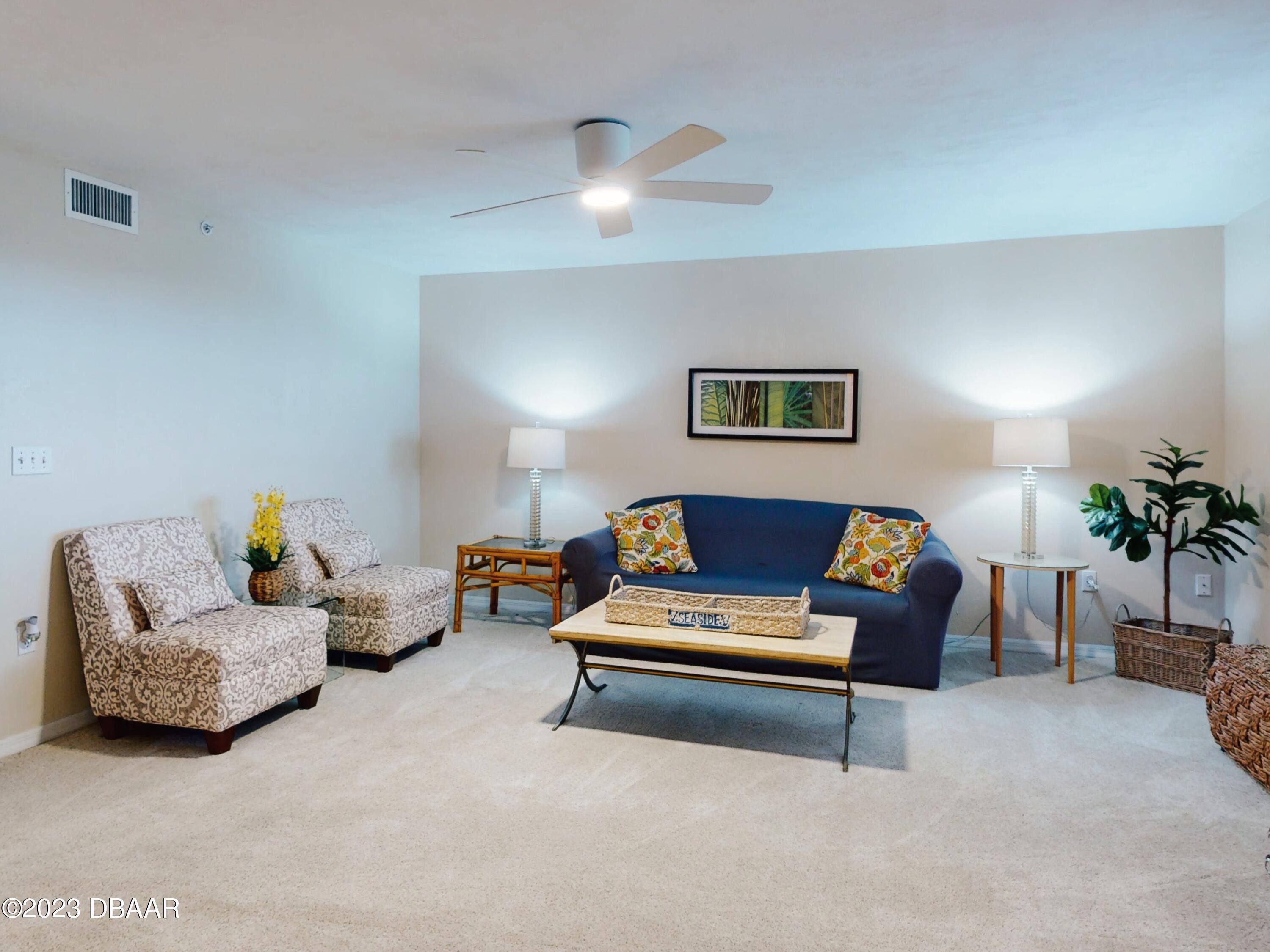 1 John Anderson Drive, Unit PH7 Ormond Beach, FL 32176 - Photo 81 of 134 a living room with furniture and a chandelier
