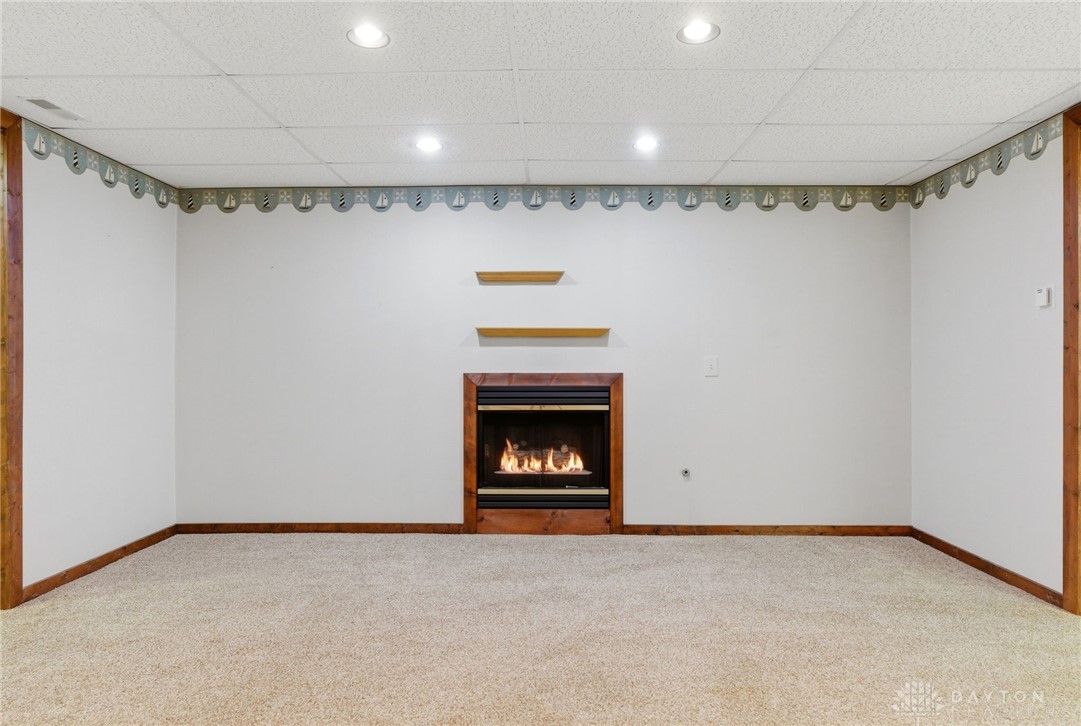 1540 Jasper Road Xenia, OH 45385 - Photo 50 of 91 This inviting basement space features a cozy fireplace, perfect for relaxation and gathering.