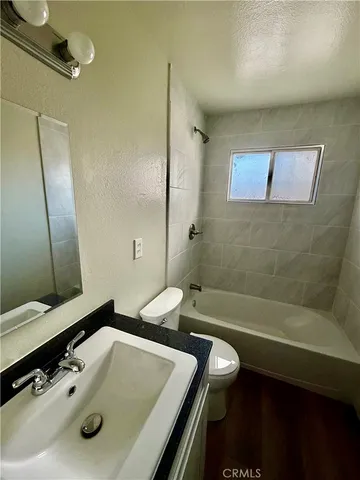 a bathroom with a tub sink and mirror