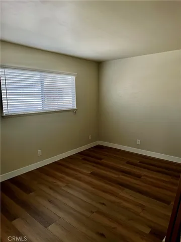 a view of a room with wooden floor and fan
