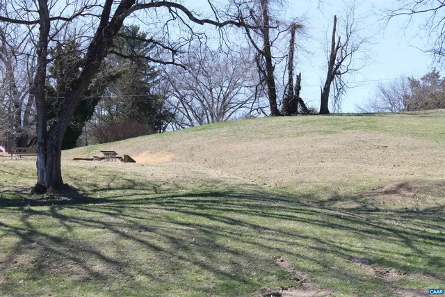 a view of a lake with wooden fence