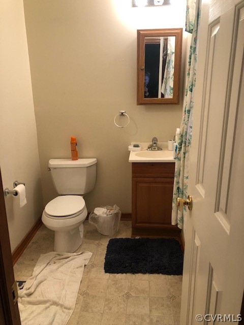 4520 River Road West Goochland, VA 23063 - Photo 13 of 18 a bathroom with a toilet a sink and mirror