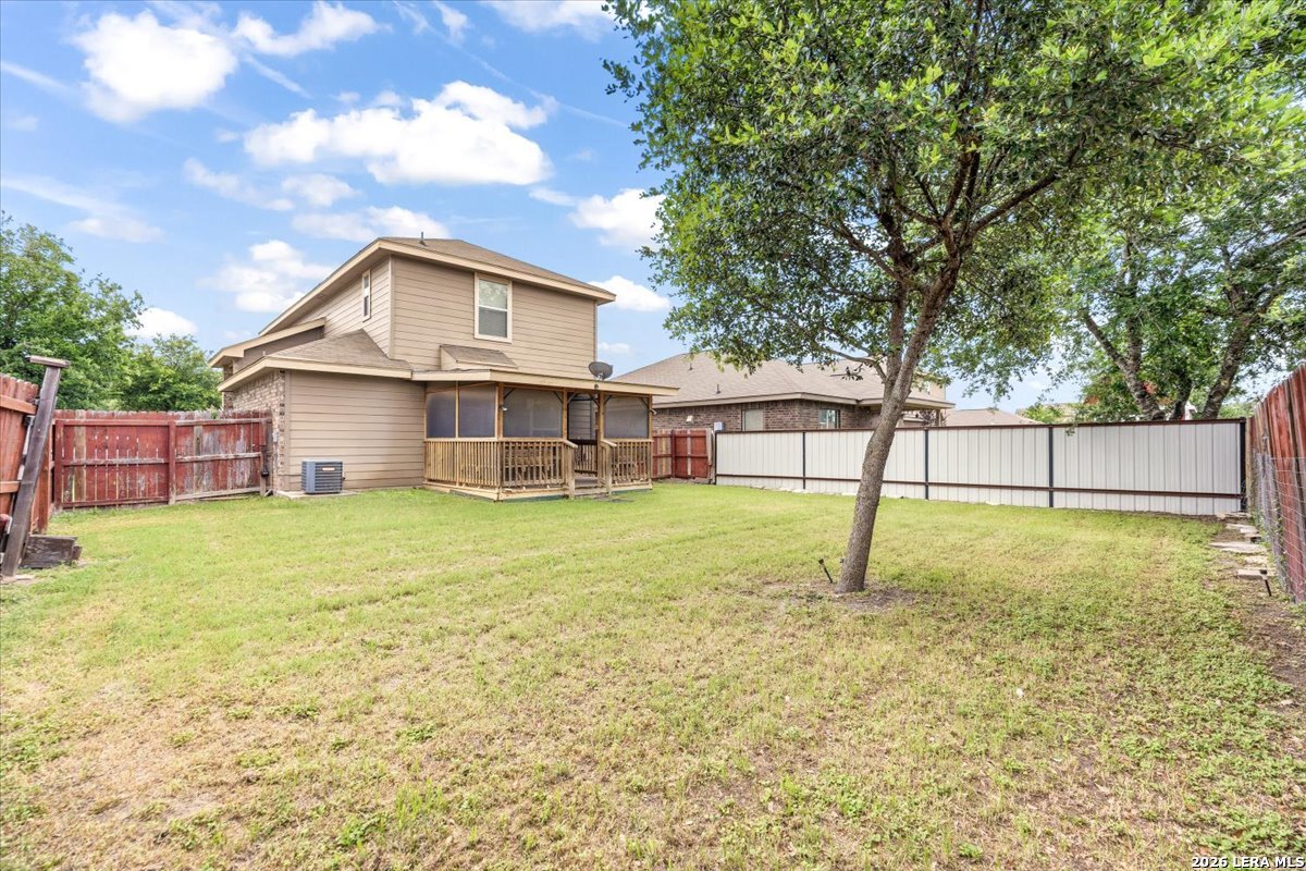3831 Bacall Way Converse, TX 78109 - Photo 30 of 33 a view of a house with a backyard and a tree