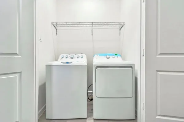 an empty room with wooden floor chandelier fan and windows