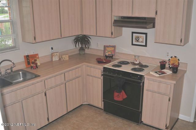 10568 Tulsa Road Jacksonville, FL 32218 - Photo 16 of 31 a kitchen with stainless steel appliances granite countertop a sink stove and cabinets