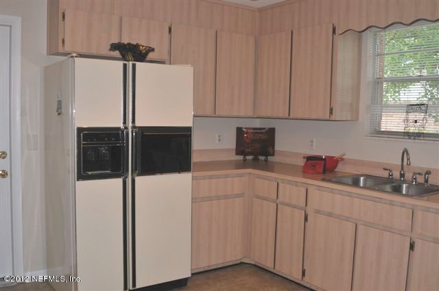 10568 Tulsa Road Jacksonville, FL 32218 - Photo 17 of 31 a kitchen with stainless steel appliances a refrigerator sink and cabinets