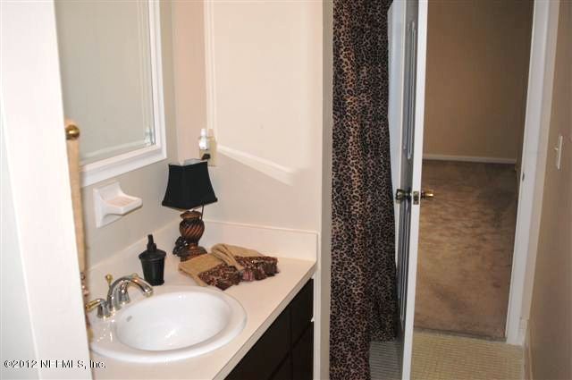 10568 Tulsa Road Jacksonville, FL 32218 - Photo 20 of 31 a bathroom with a sink and a mirror