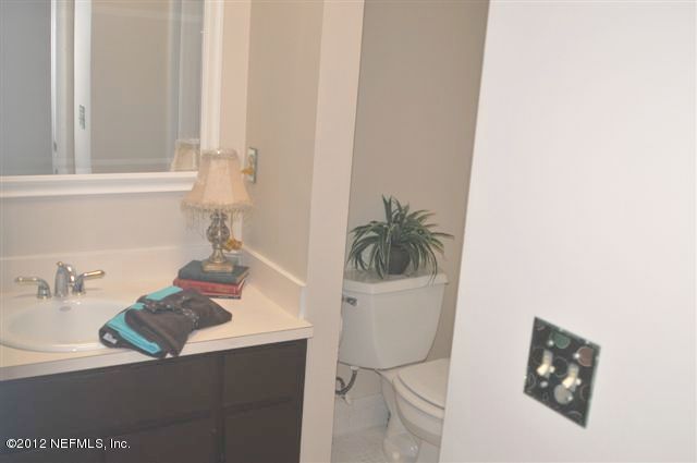 10568 Tulsa Road Jacksonville, FL 32218 - Photo 26 of 31 a bathroom with a sink and a mirror