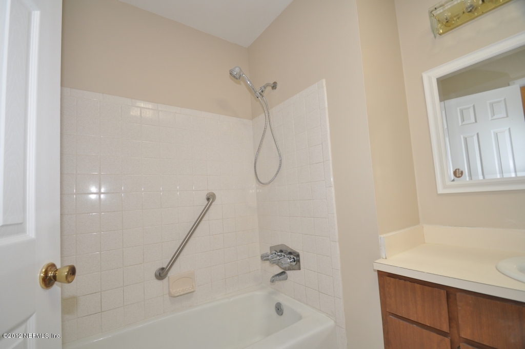 10568 Tulsa Road Jacksonville, FL 32218 - Photo 27 of 31 a bathroom with a bath tub with a shower