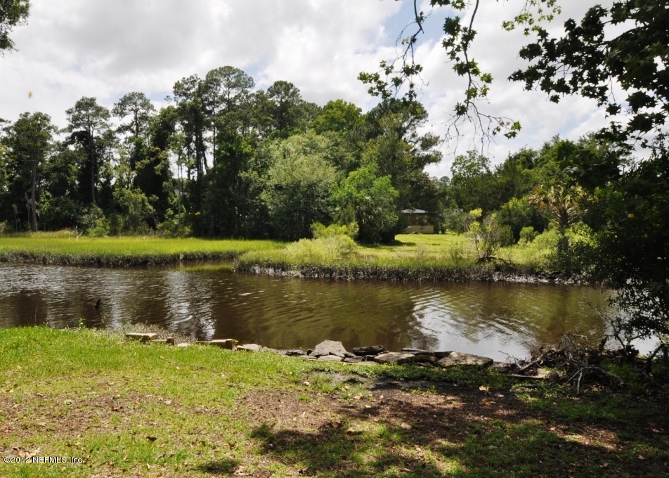 10568 Tulsa Road Jacksonville, FL 32218 - Photo 28 of 31 a view of a lake in between two trees