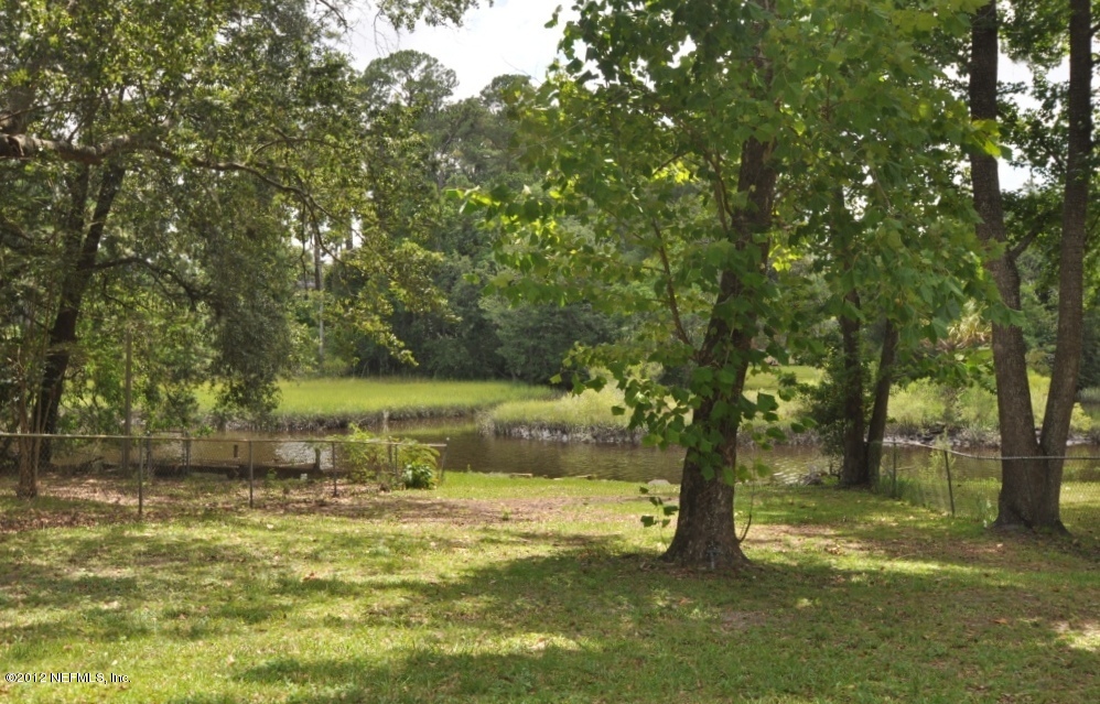 10568 Tulsa Road Jacksonville, FL 32218 - Photo 3 of 31 a view of a yard with a tree