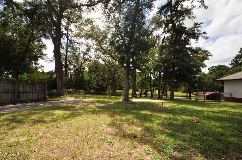 10568 Tulsa Road Jacksonville, FL 32218 - Photo 31 of 31 a swimming pool is covered with tall trees