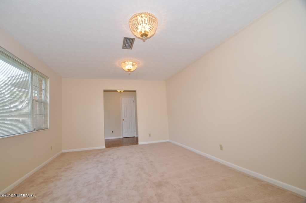 10568 Tulsa Road Jacksonville, FL 32218 - Photo 7 of 31 an empty room with a window