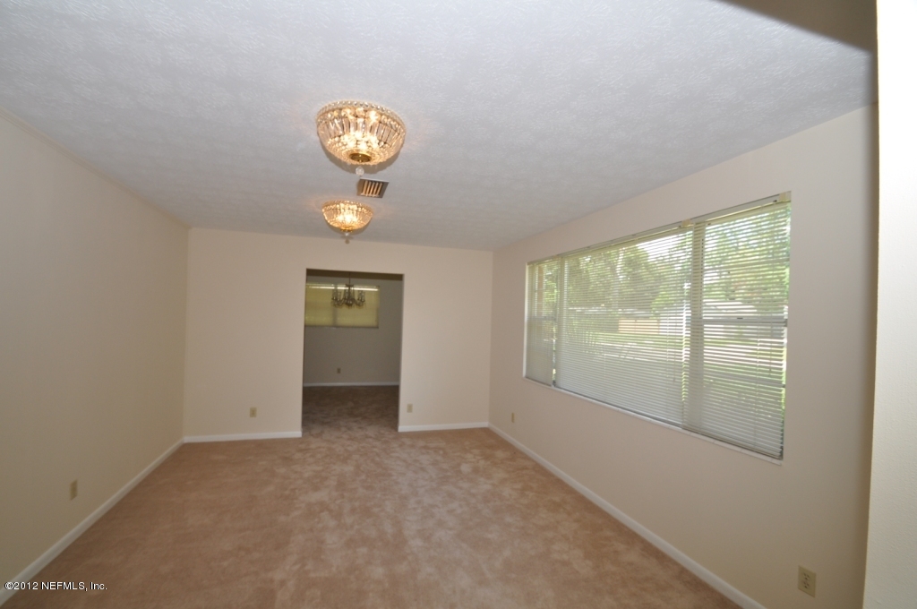 10568 Tulsa Road Jacksonville, FL 32218 - Photo 8 of 31 a view of an empty room with a window