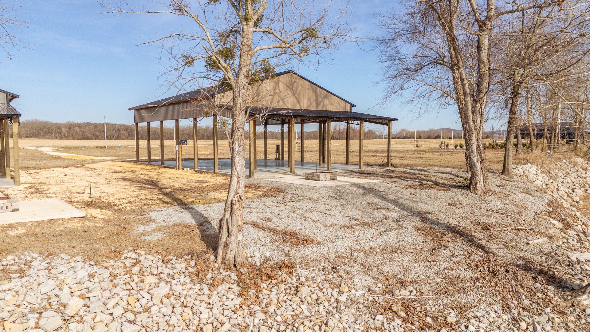 209 Hardin Bottom River Road Clifton, TN 38425 - Photo 6 of 51 a view of a yard covered with snow in the background