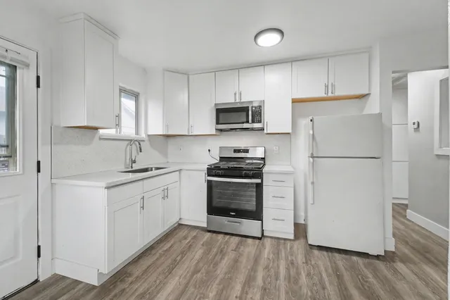 a kitchen with a refrigerator stove and sink