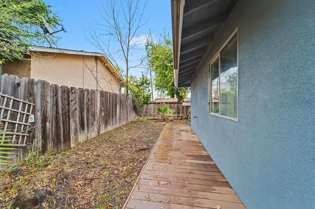 a path view of a house with wooden fence