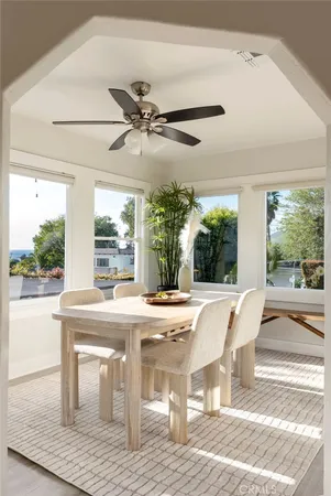 a dining room with furniture window and wooden floor