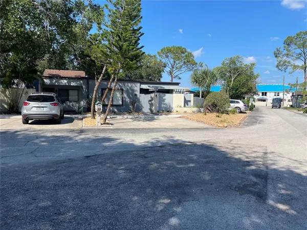 a view of a car park in front of a house