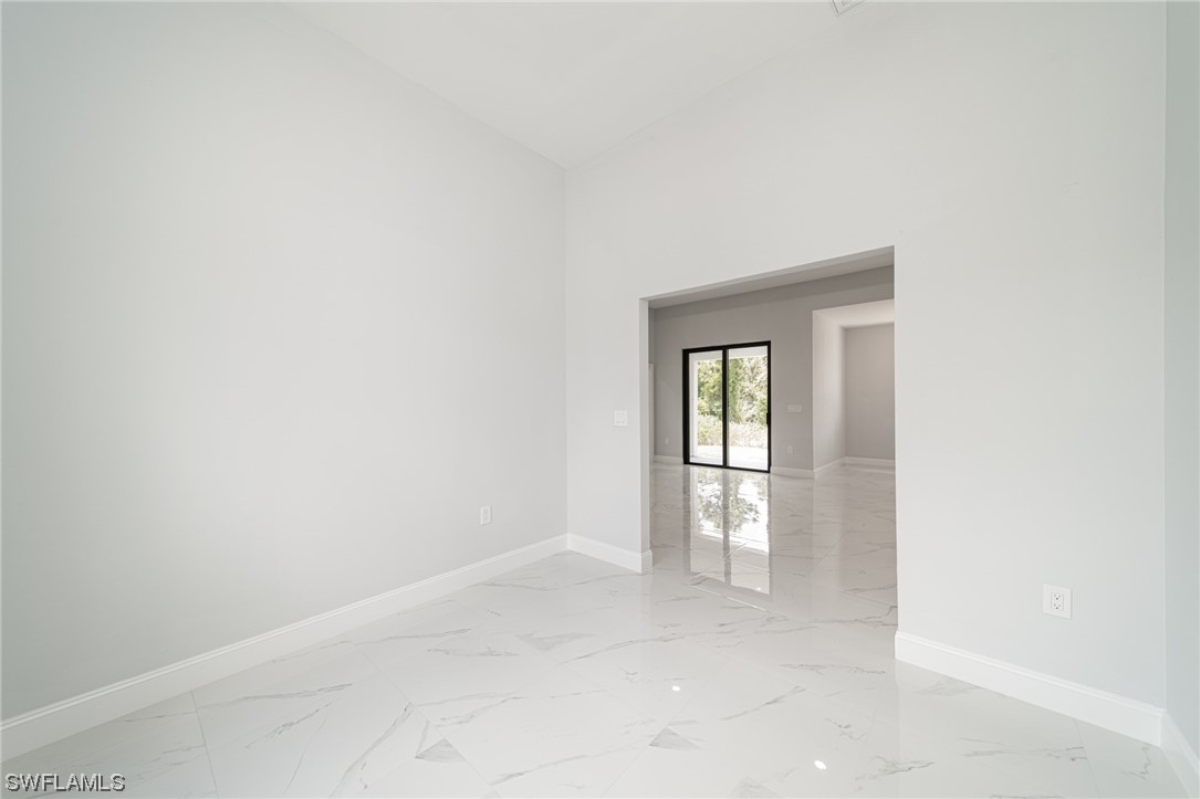 344 Rancho Avenue Lehigh Acres, FL 33974 - Photo 11 of 27 a view of an empty room with a window