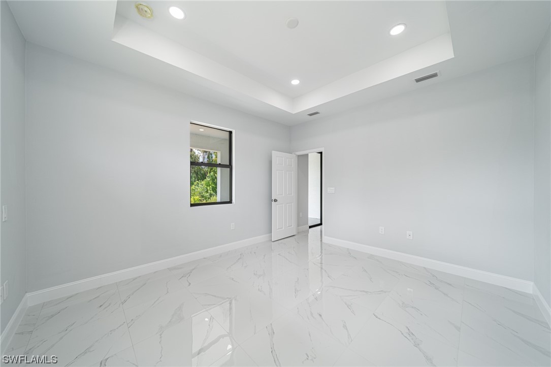 344 Rancho Avenue Lehigh Acres, FL 33974 - Photo 14 of 27 an empty room with windows