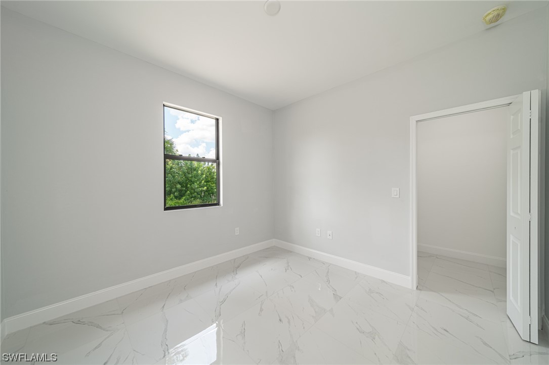 344 Rancho Avenue Lehigh Acres, FL 33974 - Photo 21 of 27 an empty room with a window