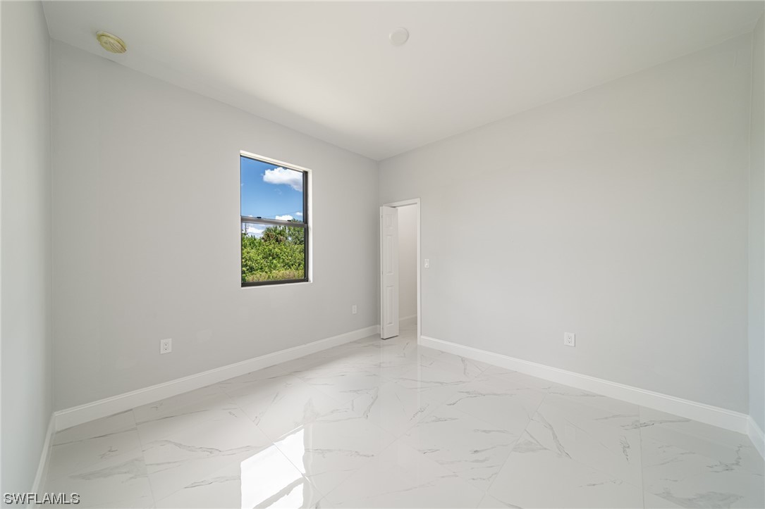 344 Rancho Avenue Lehigh Acres, FL 33974 - Photo 23 of 27 an empty room with windows