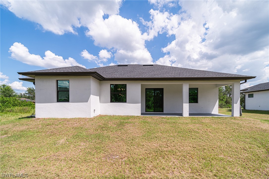 344 Rancho Avenue Lehigh Acres, FL 33974 - Photo 26 of 27 a view of a house with a patio