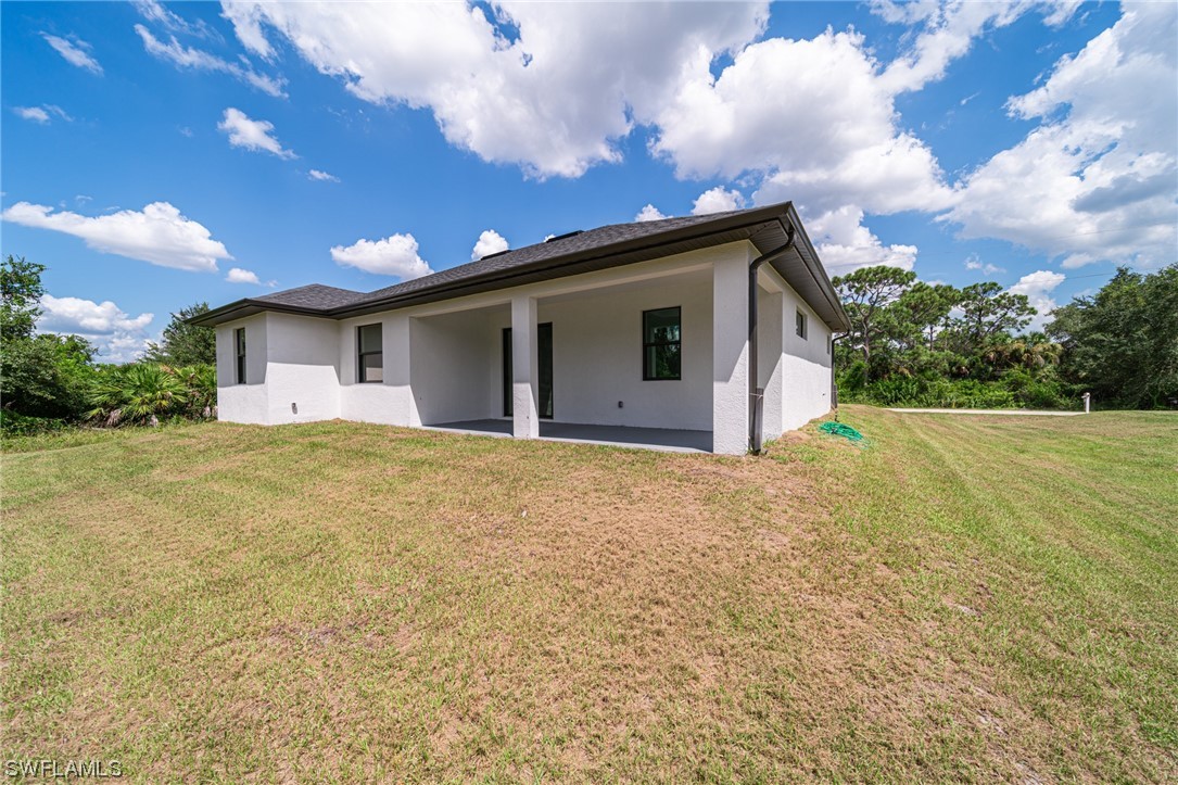 344 Rancho Avenue Lehigh Acres, FL 33974 - Photo 3 of 27 a front view of house with yard