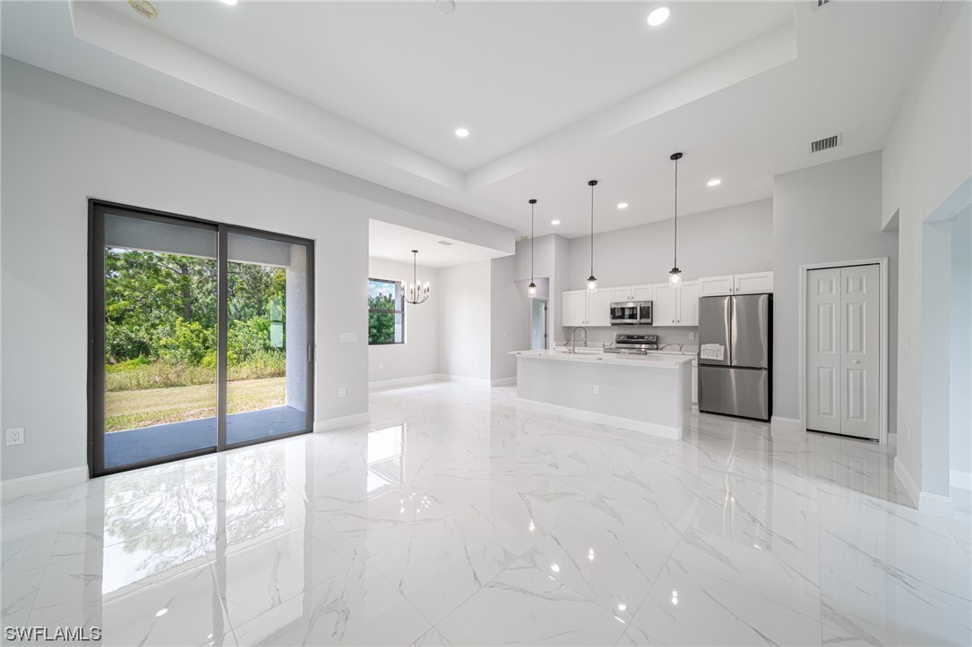 344 Rancho Avenue Lehigh Acres, FL 33974 - Photo 4 of 27 a view of kitchen with stainless steel appliances refrigerator oven and cabinets