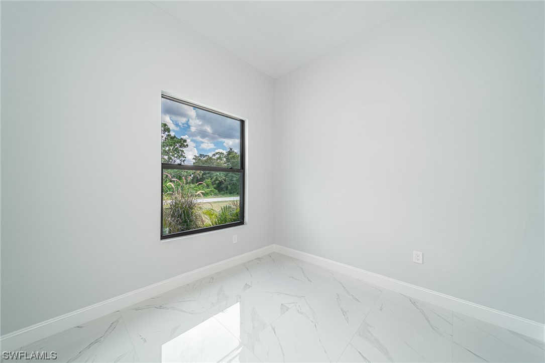 344 Rancho Avenue Lehigh Acres, FL 33974 - Photo 10 of 27 an empty room with a window