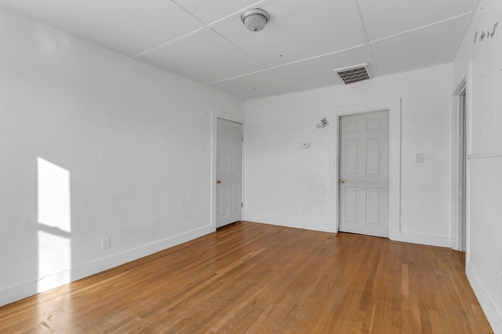 13 R Plain Street, Unit 3 Taunton, MA 02780 - Photo 6 of 19 a view of empty room with wooden floor and fan