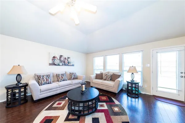 a living room with furniture a rug and a table