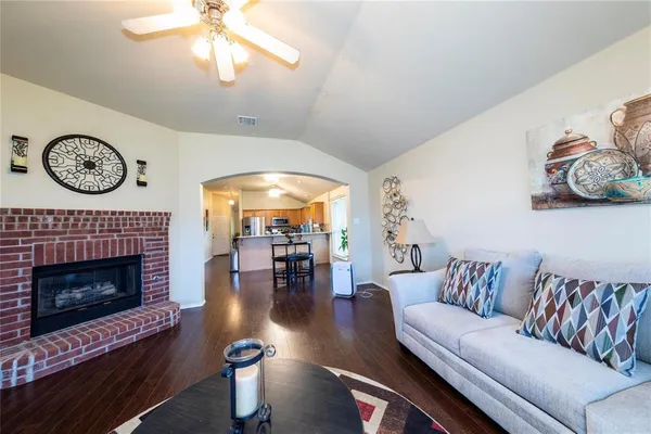 a living room with furniture a fireplace and a large window
