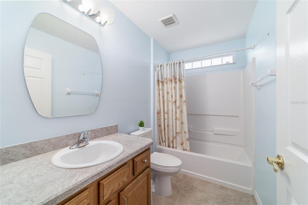 16369 Southwest 14th Avenue Road Ocala, FL 34473 - Photo 36 of 49 a bathroom with a granite countertop sink toilet and shower