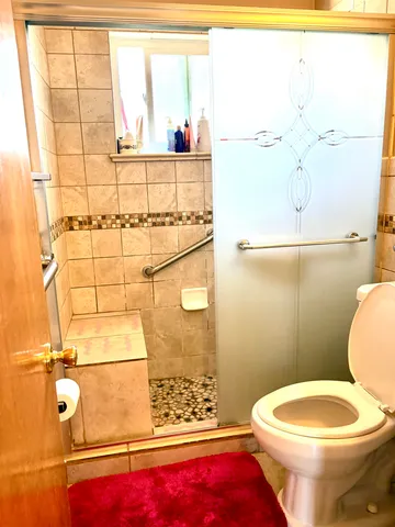 a bathroom with a toilet and a shower