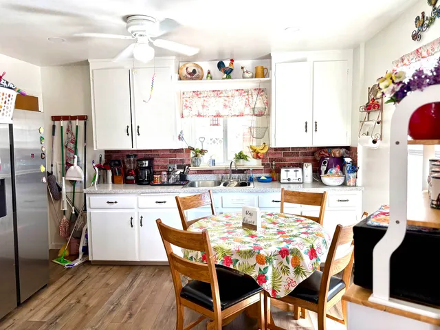 a view of a dining room with furniture and a kitchen