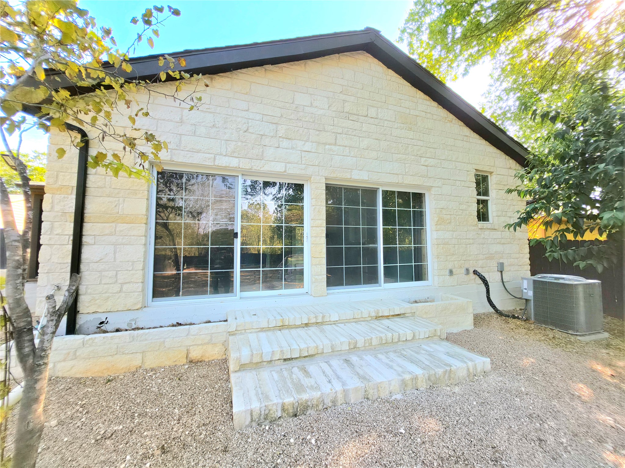 2201 Teri Road Austin, TX 78744 - Photo 34 of 40 Textured light stone masonry defines the exterior of this single-story structure.