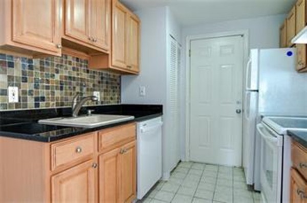 2 Walden Drive, Unit 5 Natick, MA 01760 - Photo 2 of 18 a kitchen with a sink and cabinets