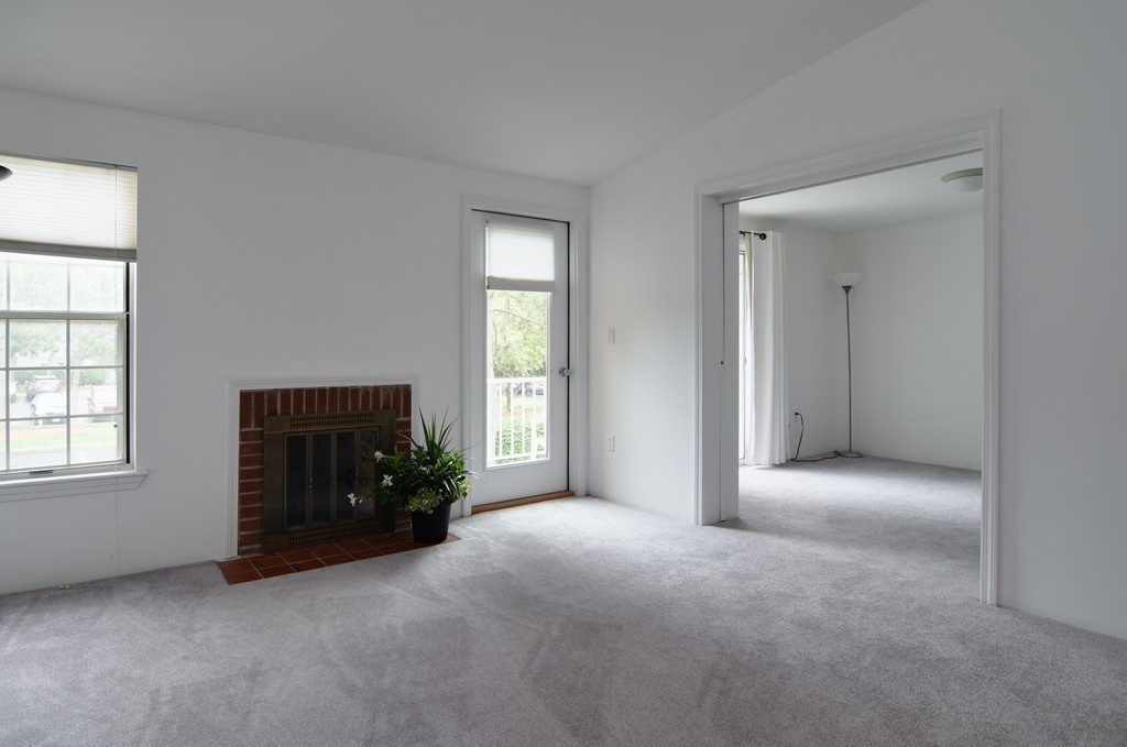 2 Walden Drive, Unit 5 Natick, MA 01760 - Photo 6 of 18 an empty room with windows and fireplace