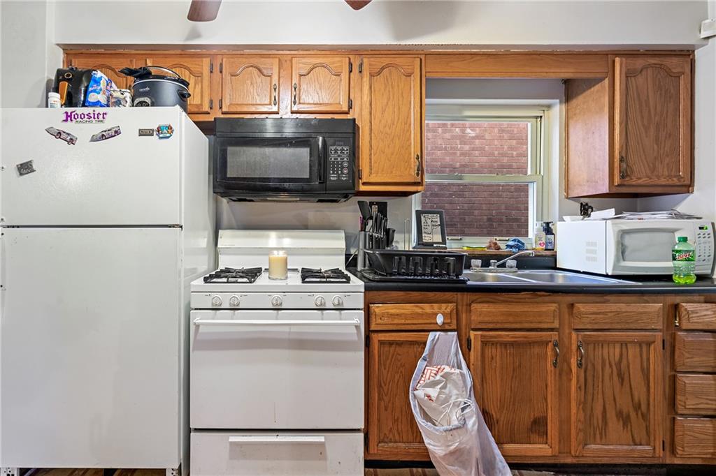 811 6th Street McKees Rocks, PA 15136 - Photo 9 of 19 a kitchen with stainless steel appliances granite countertop a refrigerator sink stove and microwave