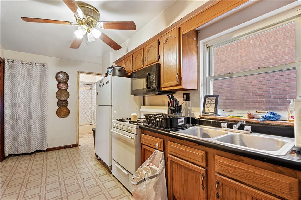 811 6th Street McKees Rocks, PA 15136 - Photo 10 of 19 a kitchen with stainless steel appliances a sink a refrigerator and cabinets