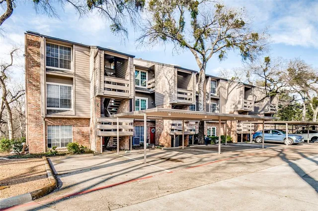 a city street lined with buildings and trees