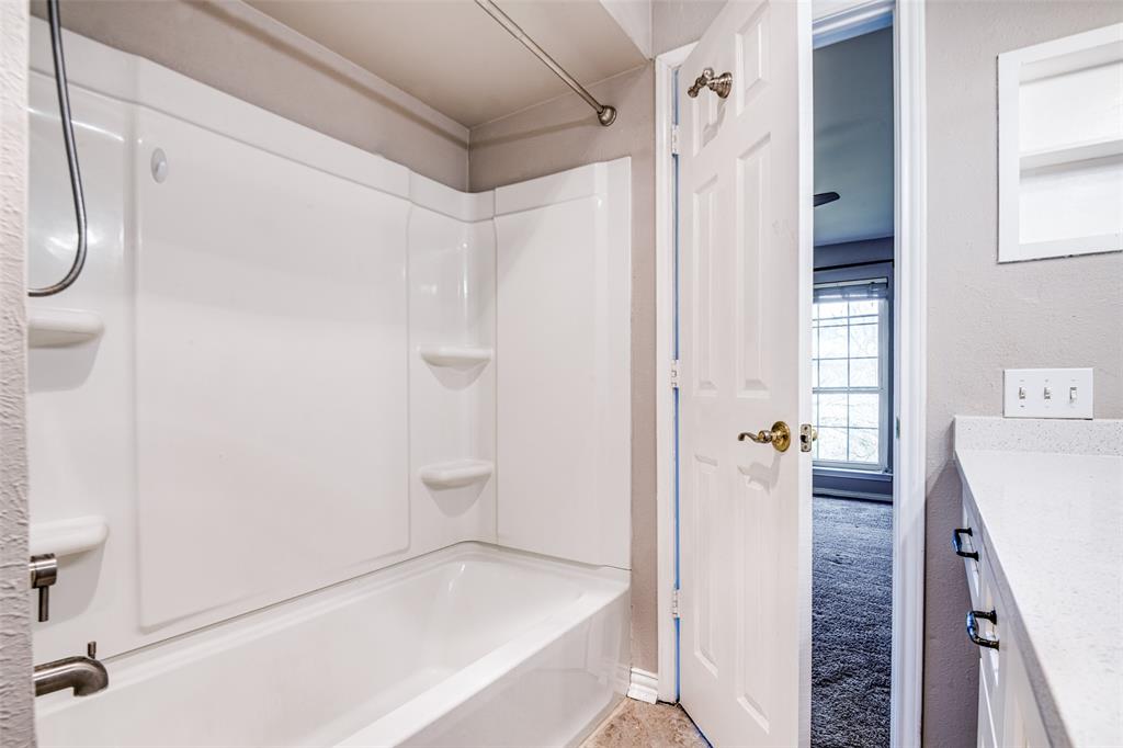 9801 Royal Lane, Unit 711 Dallas, TX 75231 - Photo 15 of 23 a bathroom with a bathtub and a shower