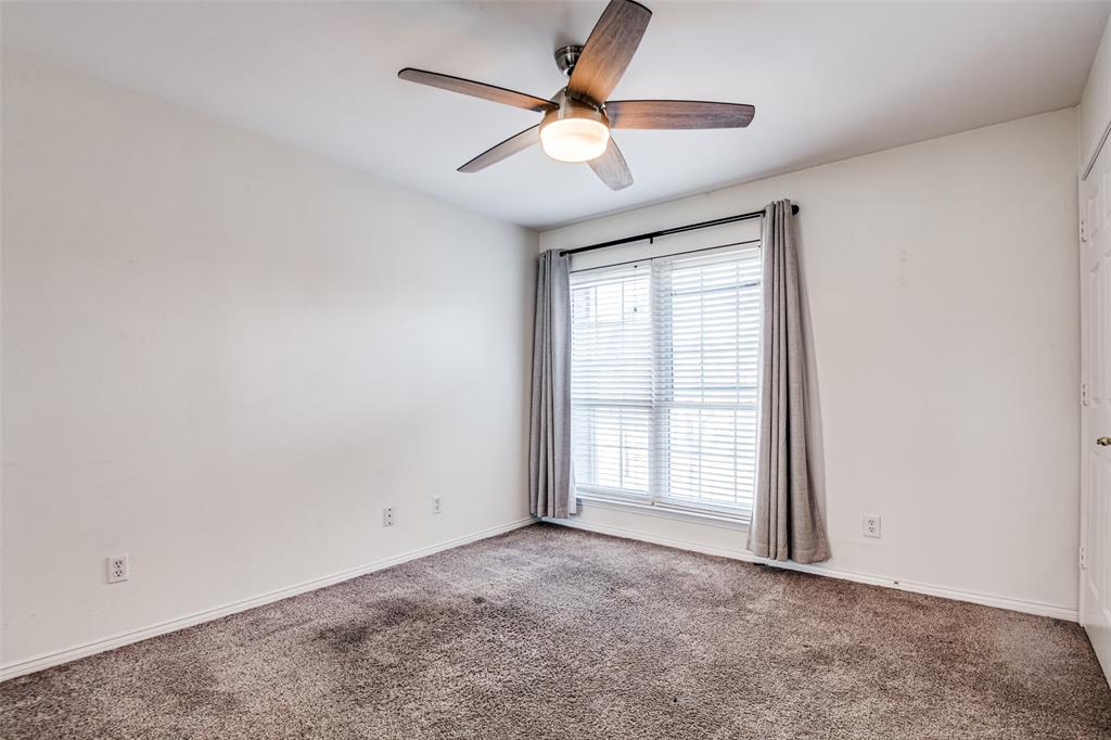 9801 Royal Lane, Unit 711 Dallas, TX 75231 - Photo 18 of 23 an empty room with fan and windows