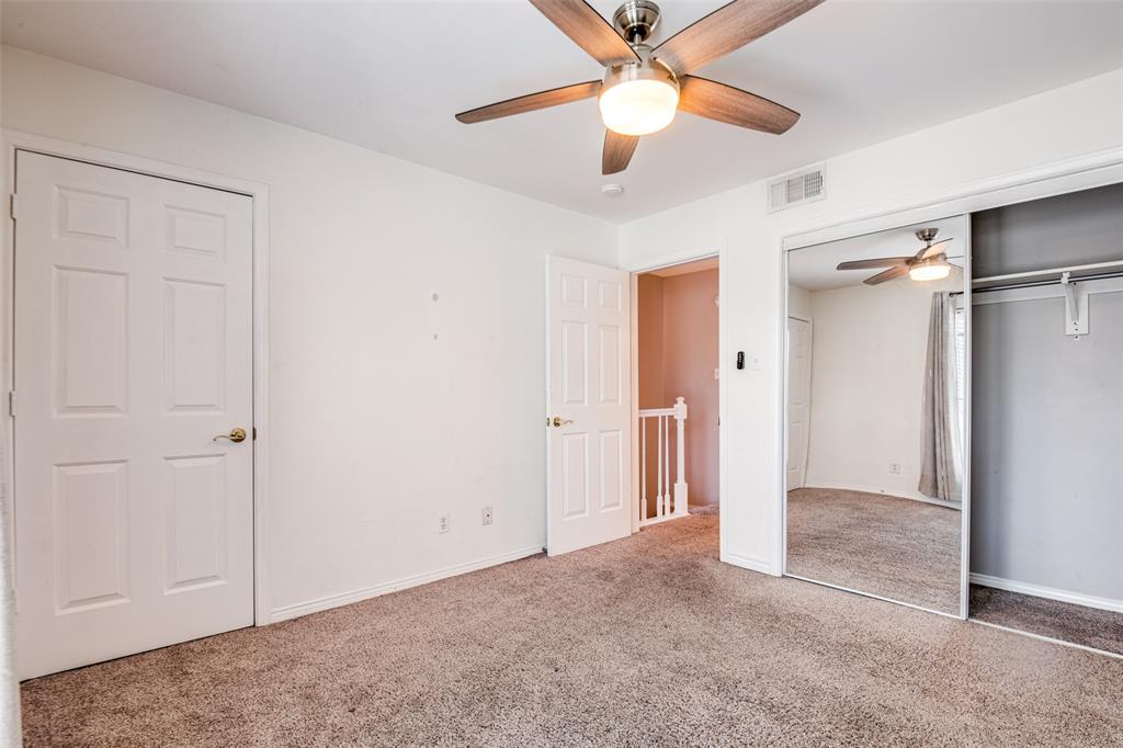 9801 Royal Lane, Unit 711 Dallas, TX 75231 - Photo 19 of 23 an empty room with closet and a chandelier fan